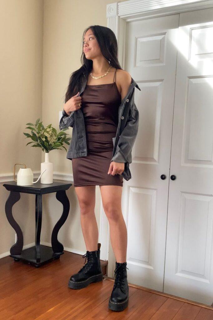 A girl in bodycon dress and boots