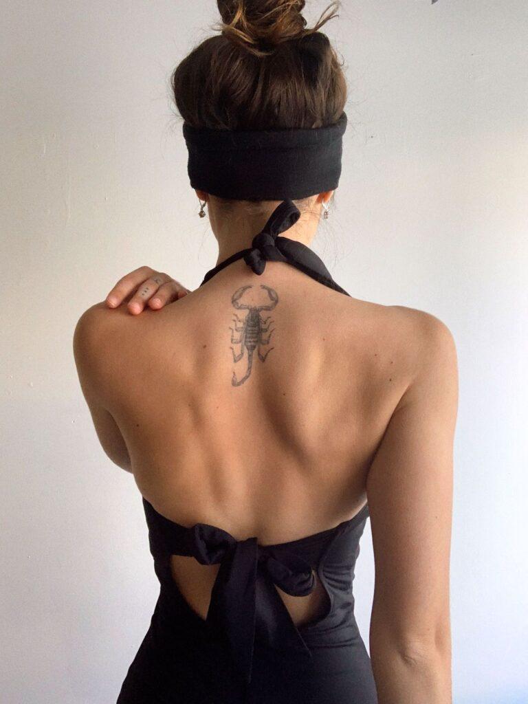 Scorpion spine tattoo for a woman