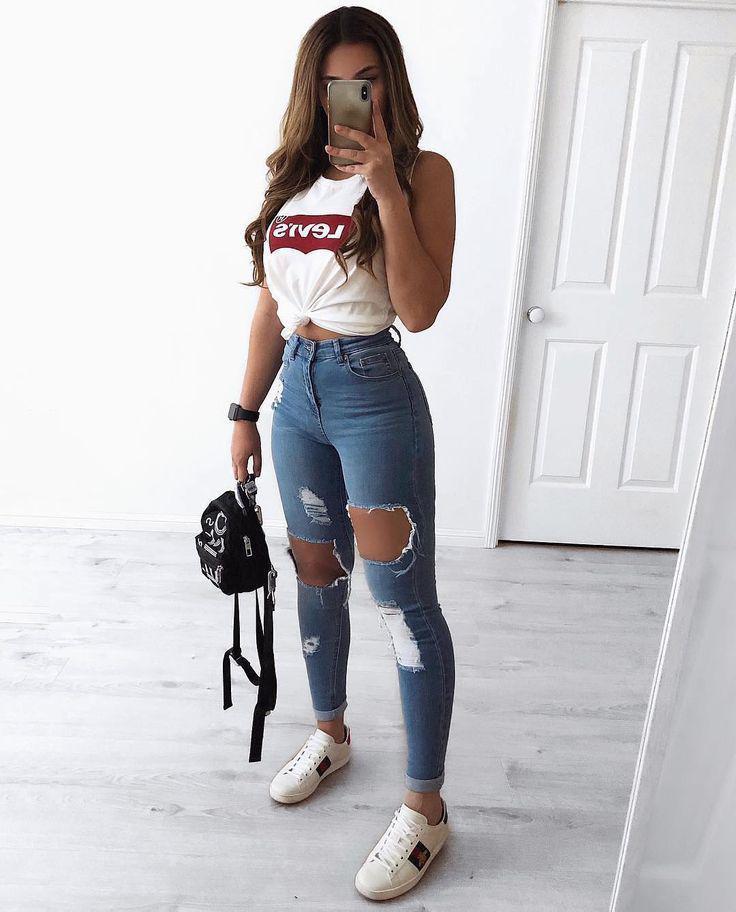 A baddie girl in ripped jeans and sneakers