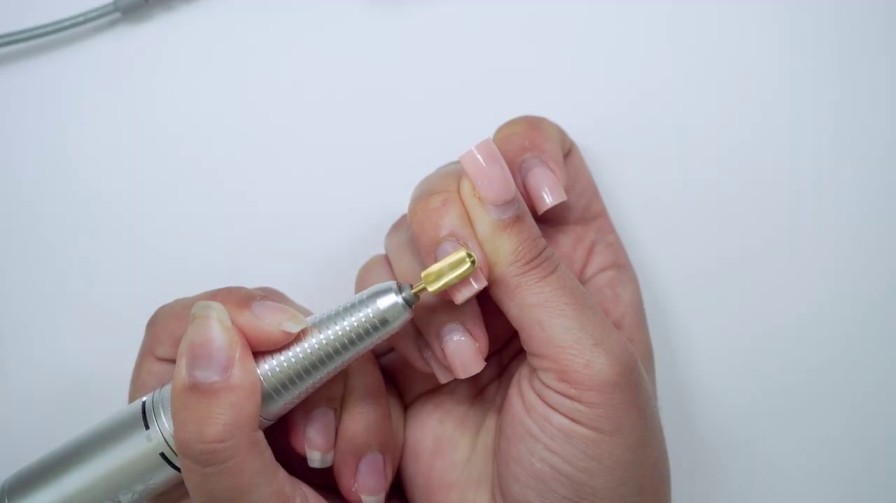 Filling nails using a drill