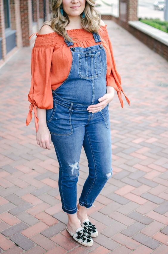 Maternity overalls with a basic tee and canvas sneakers